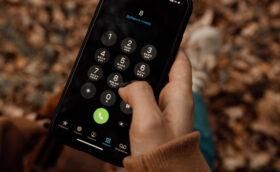 A person is using a mobile phone to key in a phone number.