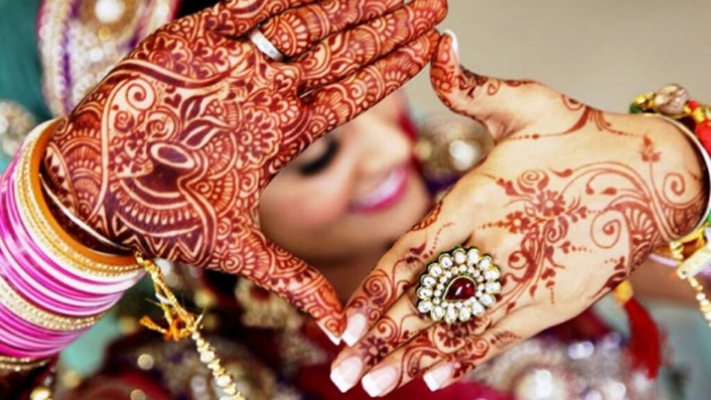 Indian Bride Have Applied Beautiful Henna On Her Hand.