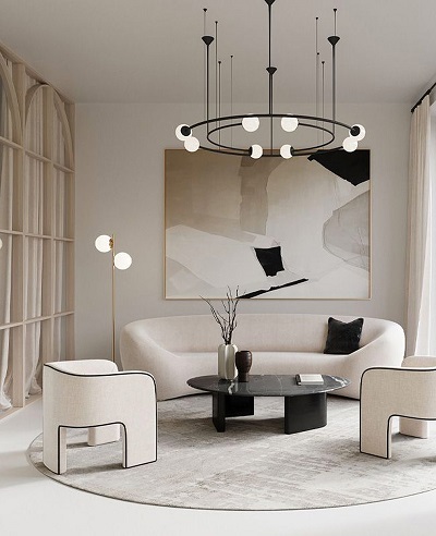 Circular sofas, painting on the wall and a circular chandelier make a beautiful living room which is predominantly white