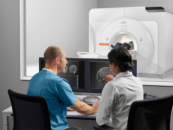 Two people discussing on the scan image of patient